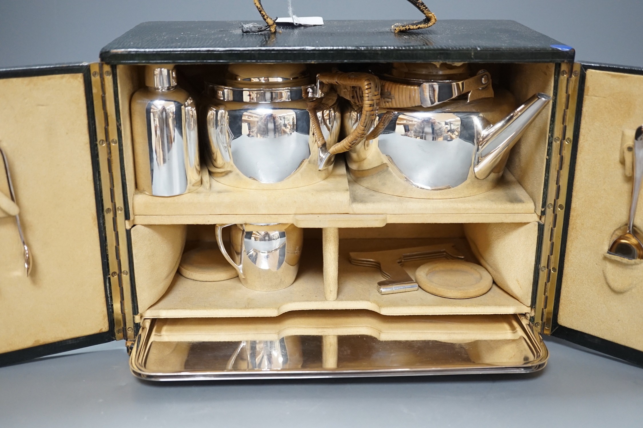 Christopher Dresser for Hukin and Heath, a silver plated travelling picnic / teaset, in suede lined green morocco case, case 21 cms x 29 cms